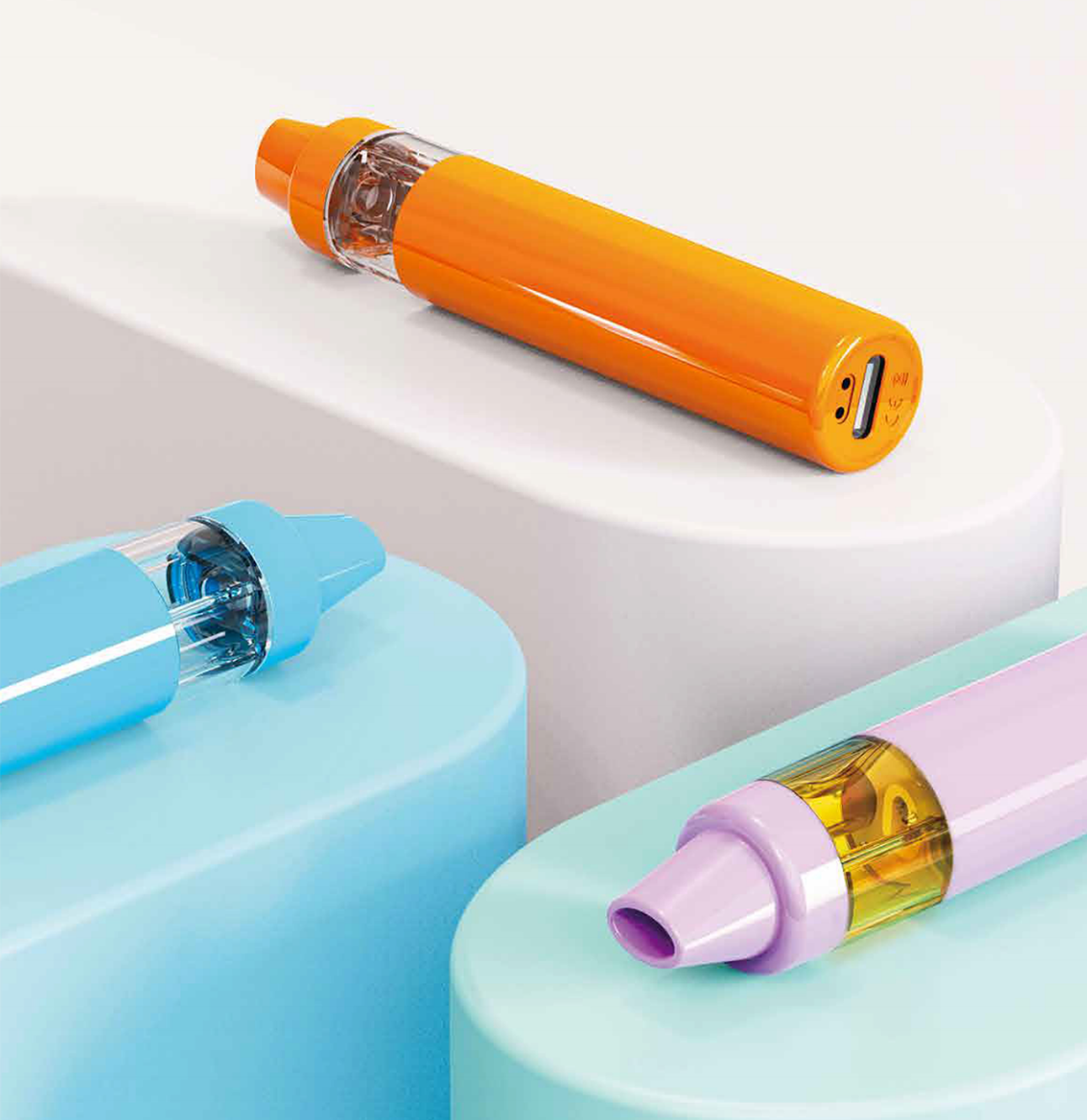 Three colorful ready to be filled vape devices on a light blue surface with a white background